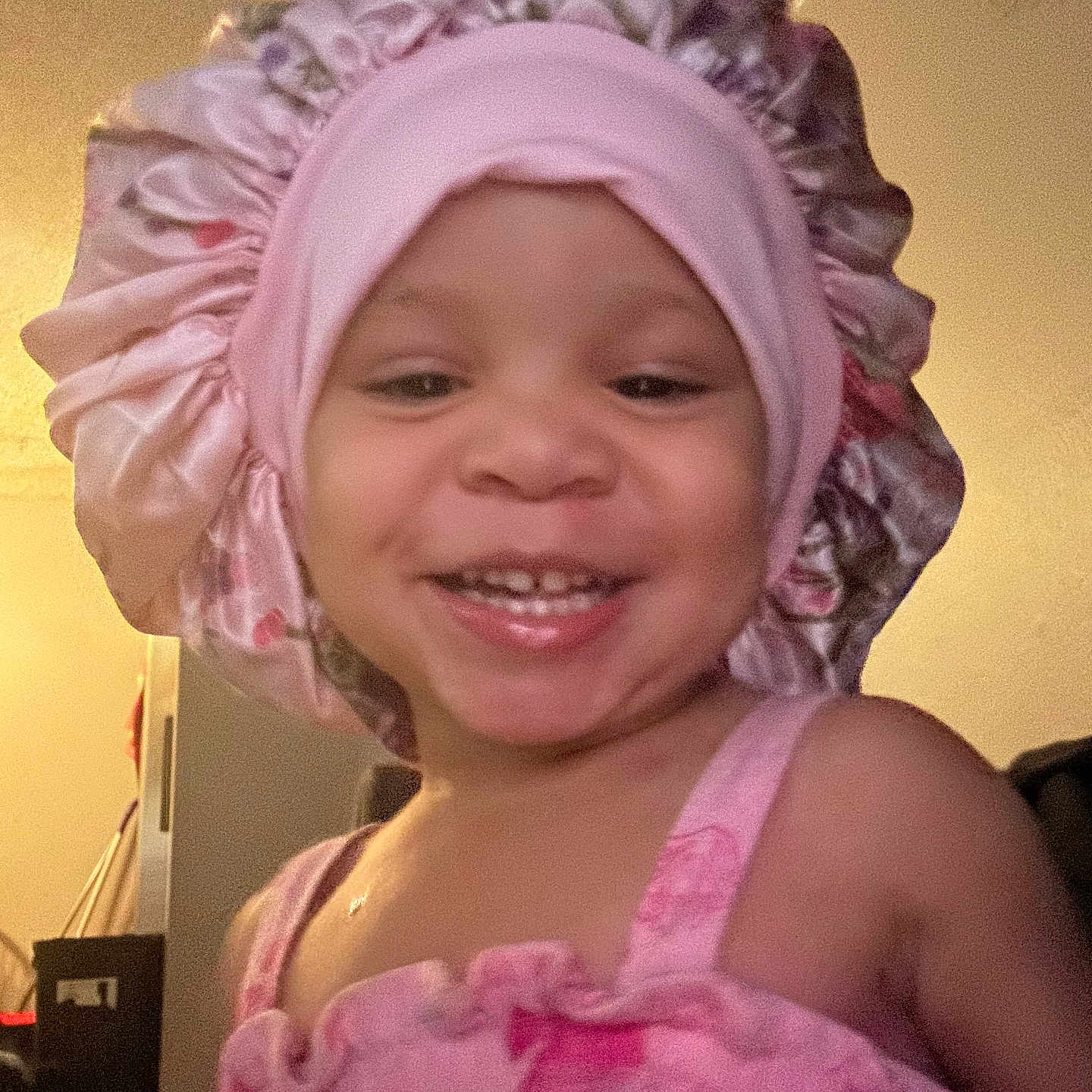 Amia Rose joined the competition — help win amazing prizes! baby, cheerful, child, closeup, clothing, cute, face, fun, happy, headwear, home, indoor, person, pink_bonnet, pink_dress, portrait, smiling, toddler, warm_lighting, young_child