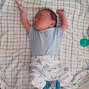 Zion joined the competition — help win amazing prizes! baby, newborn, sleeping, blanket, blue_clothing, onesie, pants, stars, moon, socks, face, infant, cute, cozy, bedroom, rest, peaceful, child, lying_down, soft
