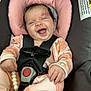 baby, infant, car_seat, smiling, happy, child, onesie, pink, orange, toy, beads, seatbelt, straps, safety, cute, portrait, indoors, clothing, head_support, playful