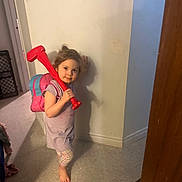 Heaven-Lleh is registered to the contest to win money with this photo: child, indoor, toy, backpack, barefoot, floor, wall, shadow, playful, curious, young, person, casual, tiled_floor, plastic_toy, smile, home, clothing, standing, light