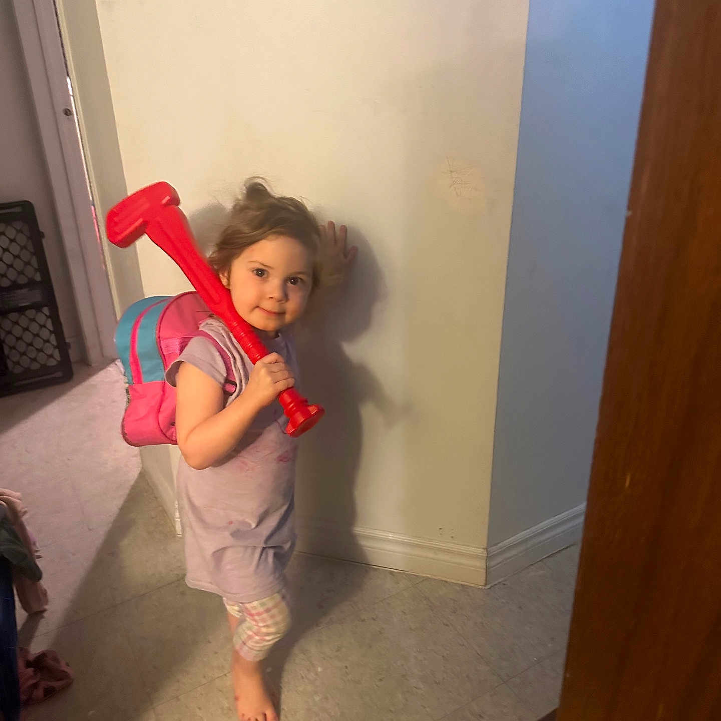 Heaven-Lleh is registered to the contest to win money with this photo: backpack, barefoot, casual, child, clothing, curious, floor, home, indoor, light, person, plastic_toy, playful, shadow, smile, standing, tiled_floor, toy, wall, young