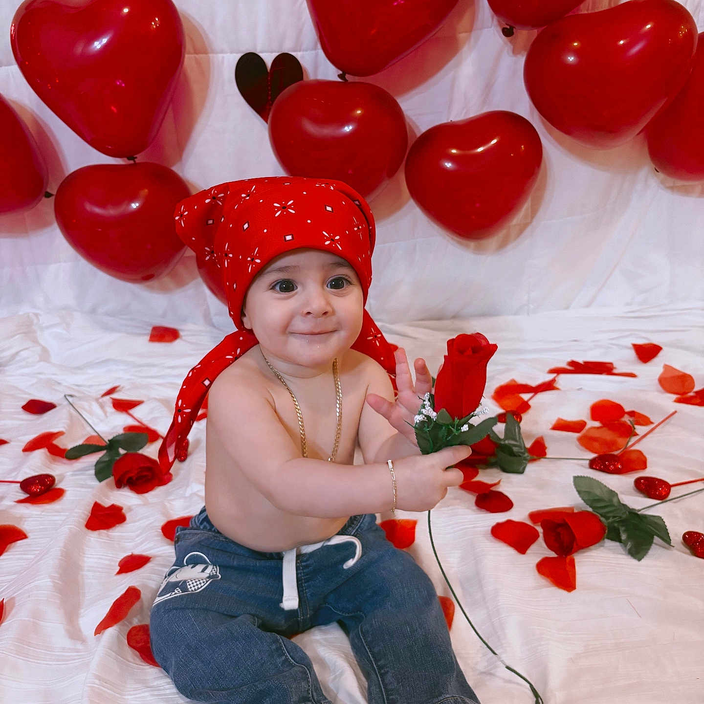 Noslen is registered to the contest to win money with this photo: baby, balloons, barefoot, big_eyes, bracelet, celebration, child, heart_balloons, infant, jeans, necklace, red_bandana, red_color, rose, rose_petals, sitting, smile, studio_shot, valentine_theme, white_backdrop