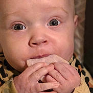 Athena joined the competition — help win amazing prizes! baby, infant, hands, eyes, close_up, portrait, onesie, leopard_print, teether, mouth, skin, cute, newborn, looking_up, indoors, blanket, seated, cheeks, stare, tiny_fingers