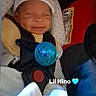 baby, infant, car_seat, pacifier, hat, smiling, child, seatbelt, clothing, blanket, indoor, cute, newborn, face, sleeping, safety, baby_gear, text_overlay, blue, adorable