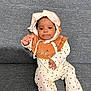Catalina a rejoint le concours — aidez-le/la à gagner de superbes lots ! baby, bodypart, bonnet, clothing, coat, face, finger, formalwear, hand, happy, hat, head, hood, pants, person, photography, portrait, sitting, smile, suit