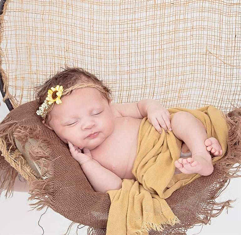 Kyreina is registered to the contest to win money with this photo: baby, baby_sleeping, baby_toddler_clothing, beige, blond, brown_hair, child, comfort, fashion_accessory, hair_accessory, hand, headgear, headpiece, pattern, person, pink, sitting, skin, sleeve, textile