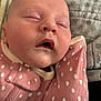 baby, sleeping, infant, face, pink_clothing, polka_dot, blanket, closeup, cozy, rest, peaceful, soft_texture, child, mouth_open, head, skin, cute, indoors, portrait, newborn