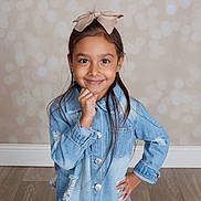 Vayda is registered to the contest to win money with this photo: bokeh, bow, casual_clothing, child, cute, denim_jacket, fashion, floor, girl, happy, headband, indoor, long_hair, person, portrait, posing, smiling, studio, wall, young