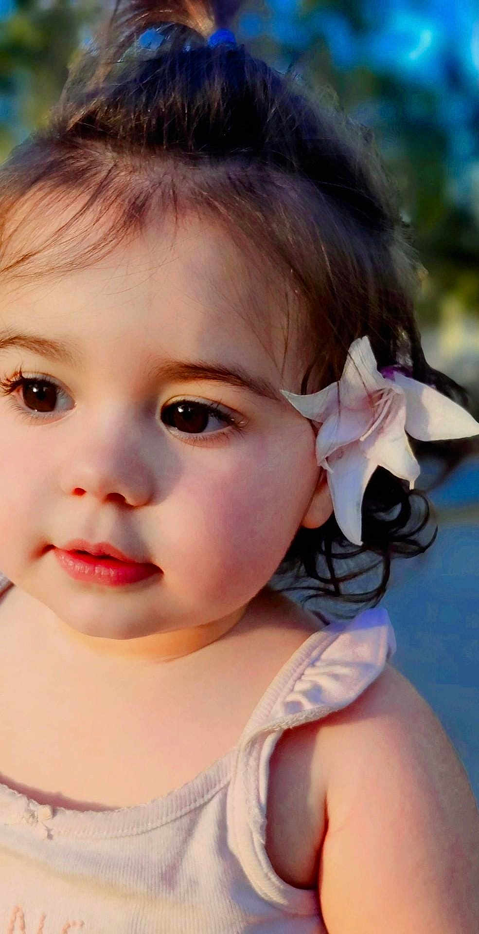 Millessa is registered to the contest to win money with this photo: toddler, child, face, flower, portrait, outdoor, soft_light, cute, young_child, skin, eyelashes, hair, shoulder, tank_top, innocence, curiosity, baby, person, closeup, summer