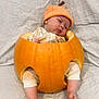 Kylo is registered to the contest to win money with this photo: baby, pumpkin, sleeping, hat, pajamas, infant, cute, autumn, orange, cozy, soft, blanket, legs, feet, headwear, resting, child, holiday, seasonal, portrait