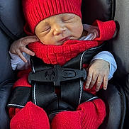 Eithan Gabriel joined the competition — help win amazing prizes! newborn, baby, sleeping, car_seat, red_hat, knitwear, scarf, mittens, booties, blanket, infant, portrait, close_up, indoors, vehicle, harness, seat_belt, peaceful, cozy, vertical_photo