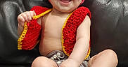 Willow joined the competition — help win amazing prizes! baby, bare_chest, child, cozy, crocheted_hat, crocheted_vest, cute, expression, foot, hand, happy, indoors, infant, leather_couch, playful, portrait, sitting, smiling, toddler, young