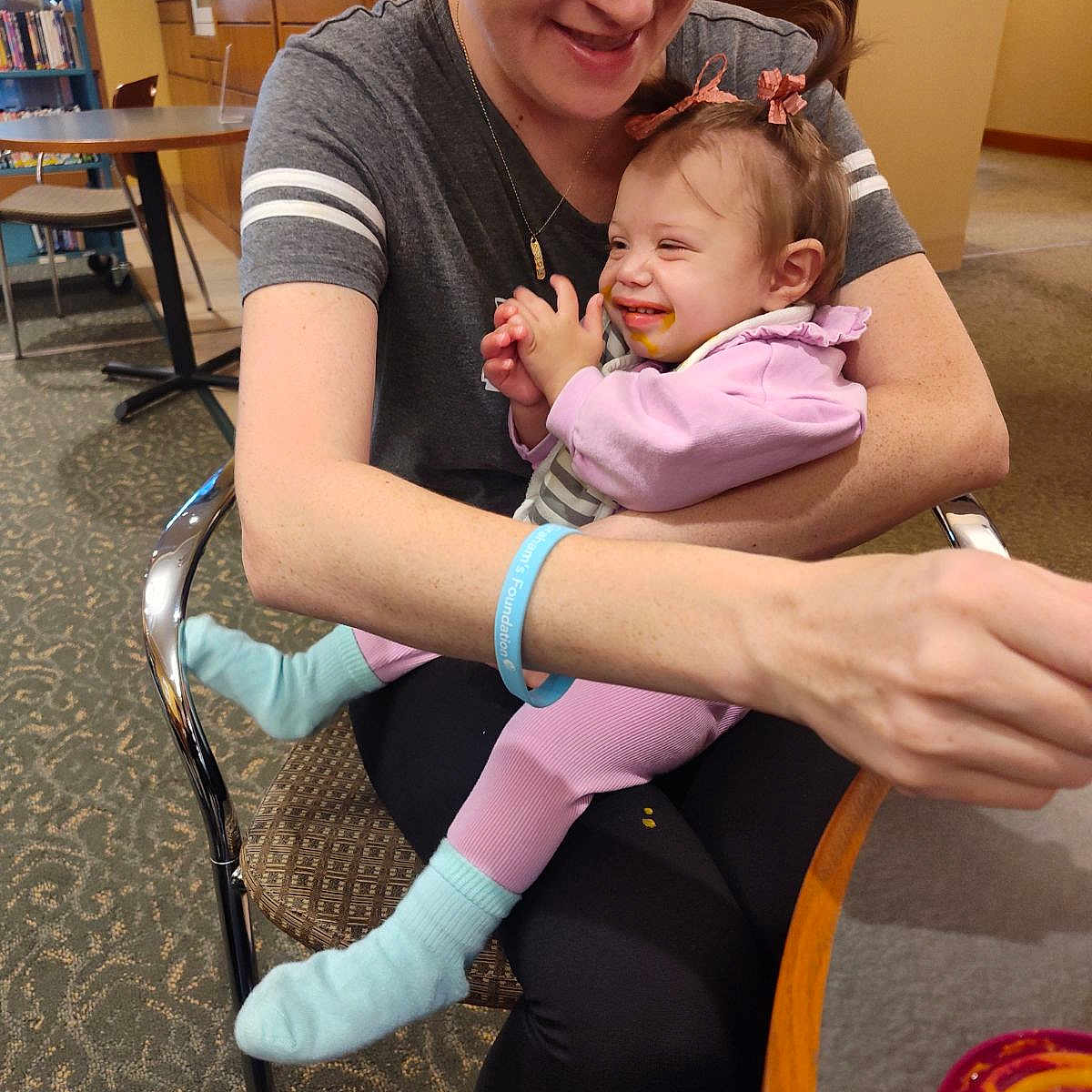 Lilith is registered to the contest to win money with this photo: accessories, baby, bracelet, chair, clothing, couch, diningtable, face, furniture, head, hosiery, indoors, jewelry, people, person, photography, portrait, sock, t_shirt, table