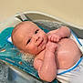 Oliver is registered to the contest to win money with this photo: baby, bathtub, water, bubbles, child, smile, skin, arms, face, head, bath_support, blue, towel, infant, cute, playful, indoors, bath_time, relaxing, young