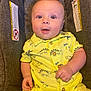 Oliver joined the competition — help win amazing prizes! baby, infant, child, car_seat, yellow_outfit, dinosaur_print, cute, smiling, portrait, indoor, clothing, hands, face, eyes, seated, young_child, happy, casual, closeup, comfortable