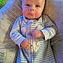 baby, infant, onesie, bunny, cushion, pattern, striped_clothing, fist, wide_eyes, cheeks, cute, lying_down, soft_toys, child, indoor, portrait, comfortable, sleepwear, expression, plush