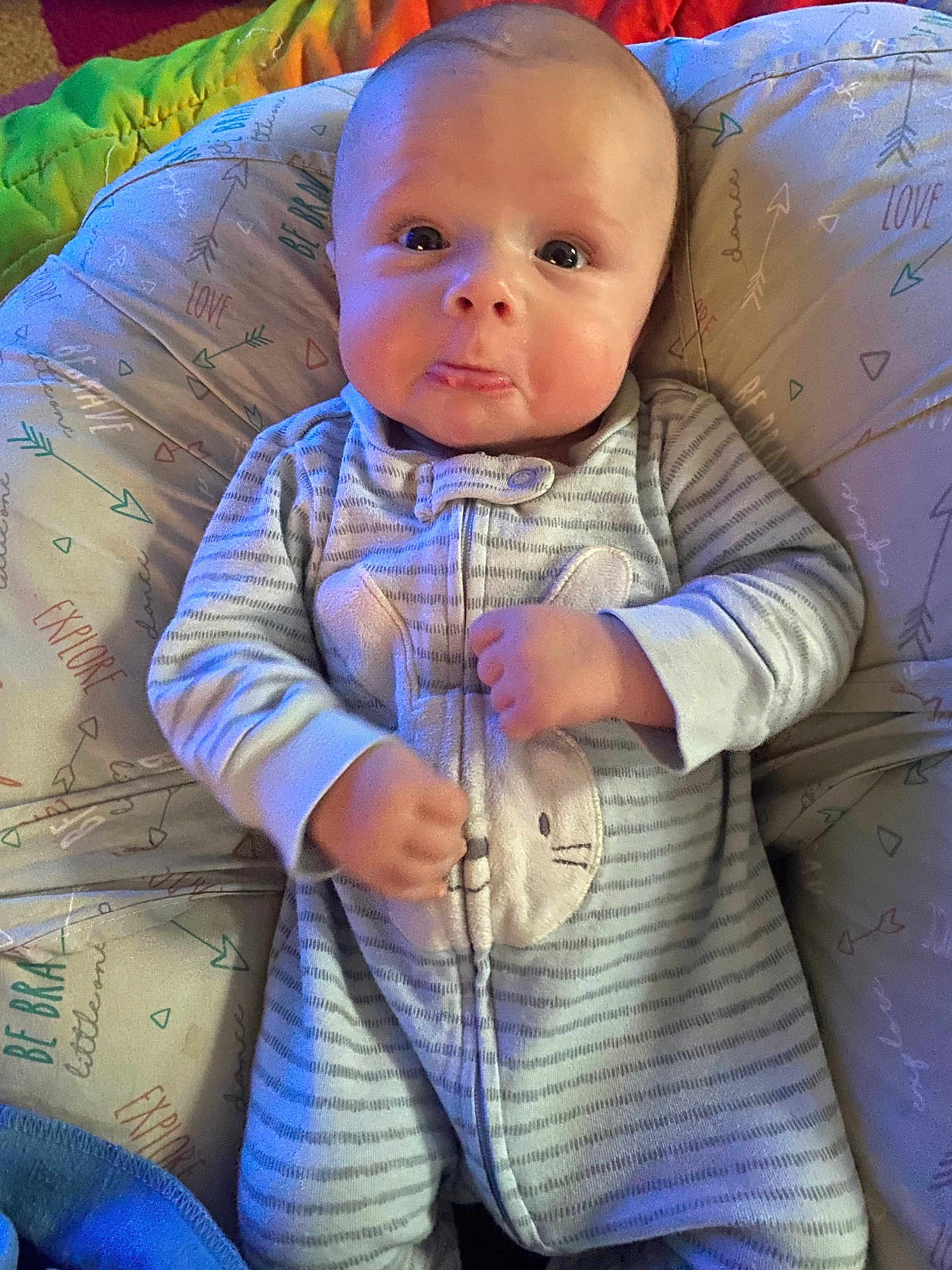 Oliver joined the competition — help win amazing prizes! baby, infant, onesie, bunny, cushion, pattern, striped_clothing, fist, wide_eyes, cheeks, cute, lying_down, soft_toys, child, indoor, portrait, comfortable, sleepwear, expression, plush