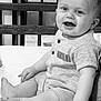 baby, bed, black_and_white, child, clothing, cute, face, foot, hand, happy, indoor, infant, mirror, monochrome, nirvana, portrait, reflection, sitting, smiling, wooden_headboard