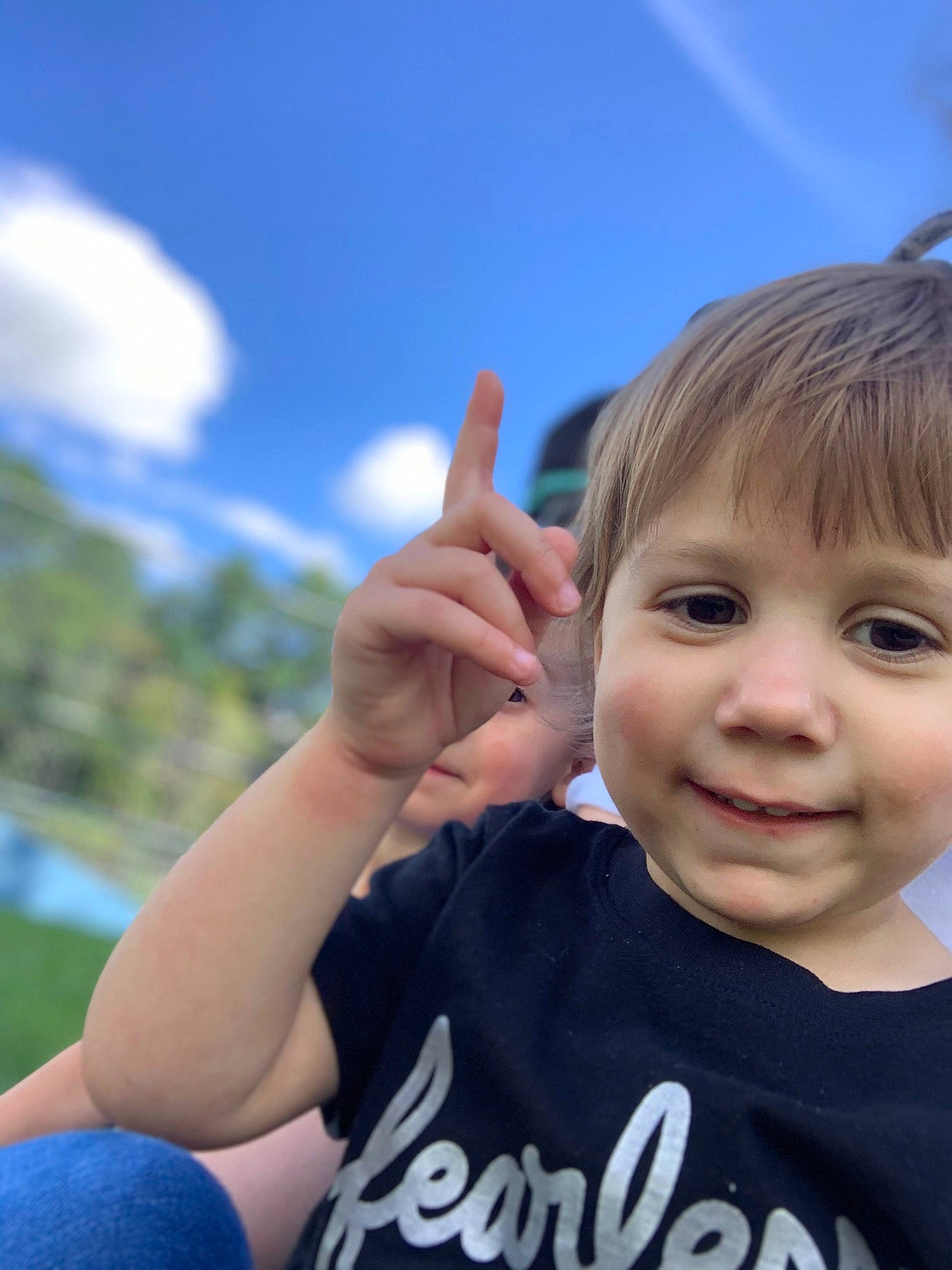Layla joined the competition — help win amazing prizes! arm, blue, cloud, electric_blue, face, finger, fun, gesture, grass, hand, happy, joy, leisure, people_in_nature, person, recreation, sky, sleeve, smile, t_shirt