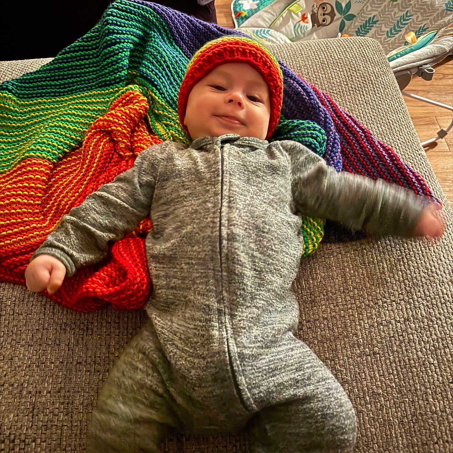 Dawson is registered to the contest to win money with this photo: baby, beanie, blanket, bodypart, bonnet, cap, clothing, couch, face, finger, furniture, hand, hat, head, knitwear, pants, person, photography, portrait, sweater