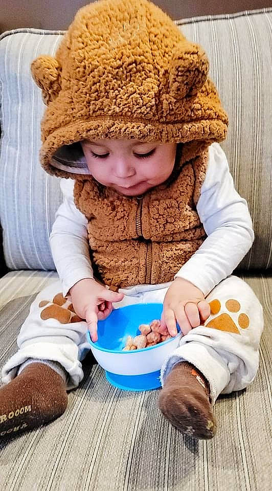 Layton is registered to the contest to win money with this photo: baby_toddler_clothing, beanie, cap, child, comfort, fashion_accessory, food, fun, happy, headwear, knit_cap, nail, pattern, people, person, play, portrait_photography, sitting, tableware, textile