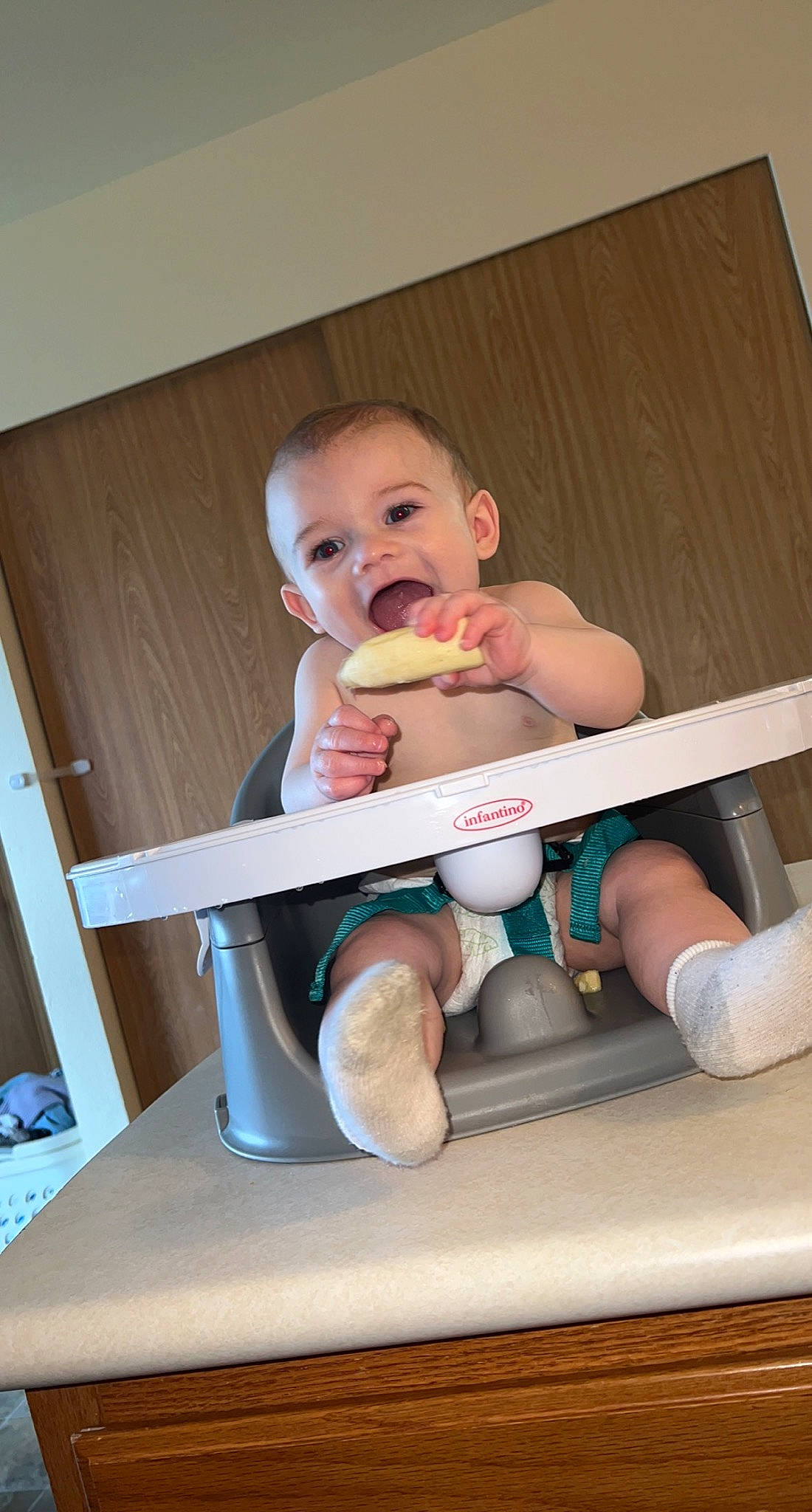 Jasper is registered to the contest to win money with this photo: baby, baby_products, baby_safety, baby_toddler_clothing, child, comfort, cooking, finger, food_craving, happy, nail, person, play, room, sitting, t_shirt, tableware, thumb, toddler, vacation