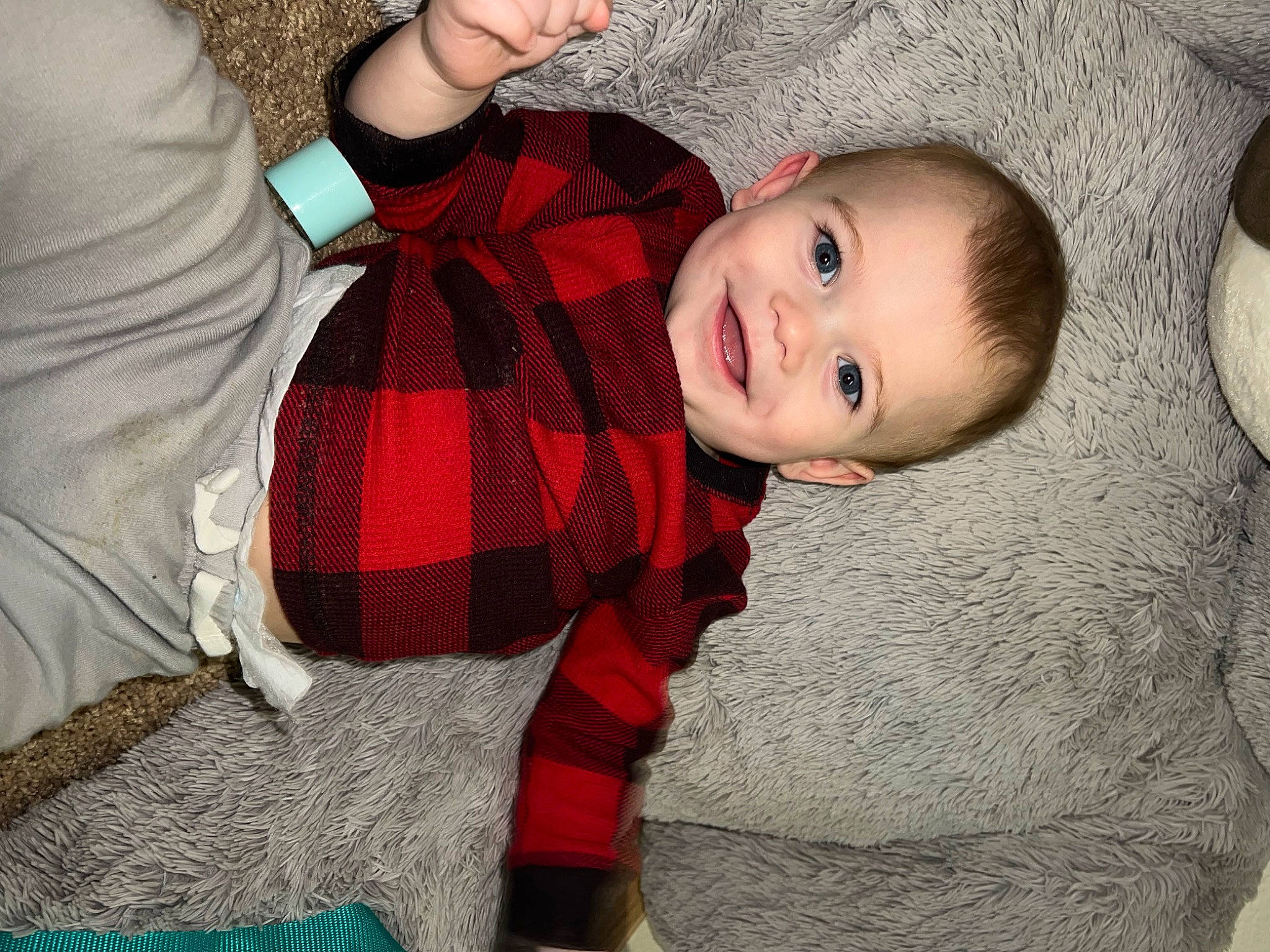 Jasper is registered to the contest to win money with this photo: baby, baby_toddler_clothing, child, comfort, eye, flash_photography, flooring, fun, fur, happy, joy, pattern, person, plaid, red, sleeve, smile, sock, tartan, textile