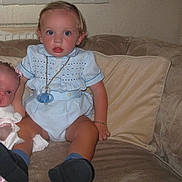 Wallace-Raymond joined the competition — help win amazing prizes! toddler, child, baby, doll, pacifier, blue_outfit, blue_eyes, couch, indoor, sitting, black_shoes, bracelet, pillow, wall, radiator, curtain, face, person, toy, furniture