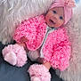 baby, pink_jacket, headband, flower, blue_eyes, soft_pillow, furry_pillow, cute, infant, sitting, smiling, indoors, cozy, footwear, tulle, happy, portrait, child, warm_clothing, headwear