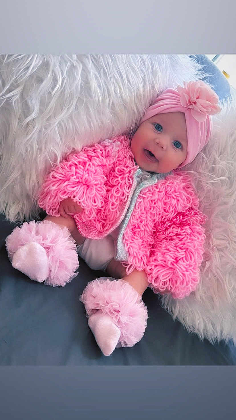 Bambi joined the competition — help win amazing prizes! baby, pink_jacket, headband, flower, blue_eyes, soft_pillow, furry_pillow, cute, infant, sitting, smiling, indoors, cozy, footwear, tulle, happy, portrait, child, warm_clothing, headwear