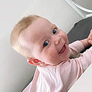 Bambi joined the competition — help win amazing prizes! baby, child, smiling, pink_clothing, blue_eyes, face, earrings, infant, portrait, happy, cheeks, skin, head, person, indoors, bed_frame, white_wall, soft_light, cute, young