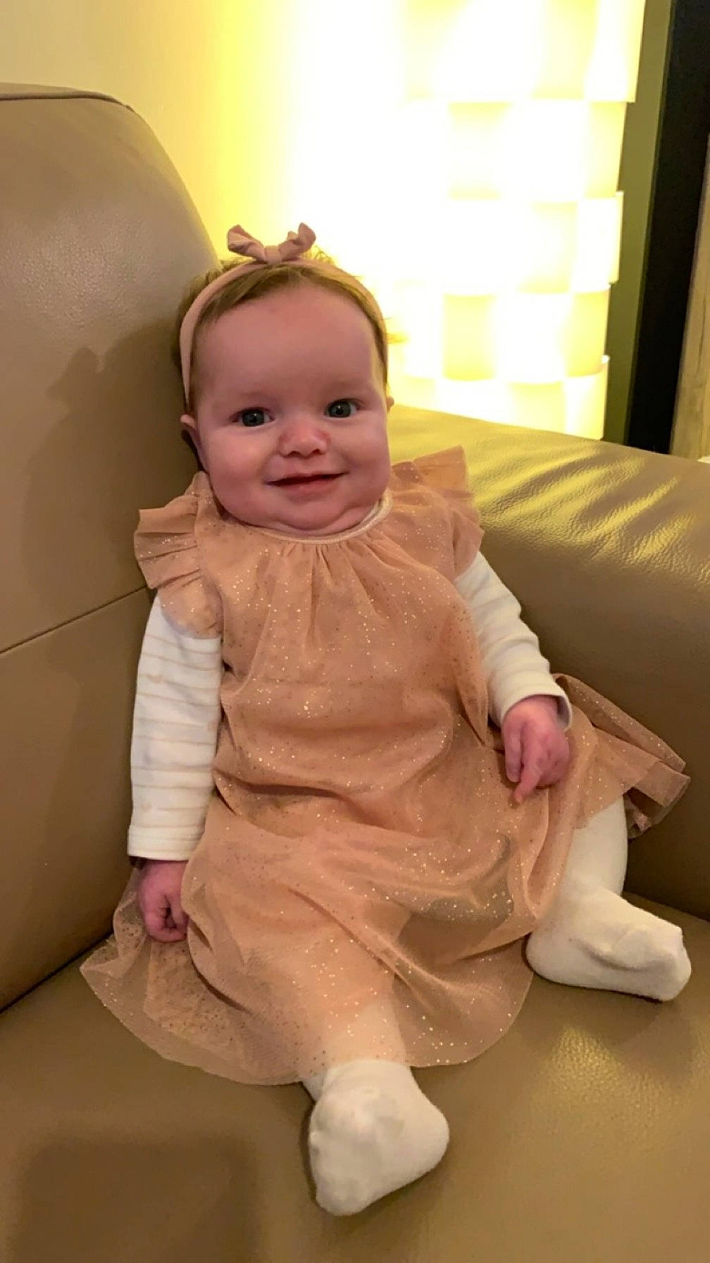 Lya participe au concours pour gagner de l'argent avec cette photo : baby, baby_toddler_clothing, cheek, child, comfort, floor, flooring, foot, fun, happy, human_leg, joy, nose, person, pink, sitting, skin, sleeve, smile, thigh