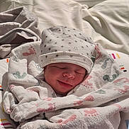 Kairo is registered to the contest to win money with this photo: newborn, baby, sleeping, blanket, hat, footprints, bed, soft, cozy, infant, wrapped, peaceful, resting, child, portrait, indoors, cute, warm, toddler, sleep