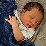 Kairo is registered to the contest to win money with this photo: newborn, baby, sleeping, blanket, blue_blanket, infant, soft_texture, hand, face, peaceful, resting, cute, closeup, indoors, clothing, white_clothing, star_pattern, skin, head, portrait