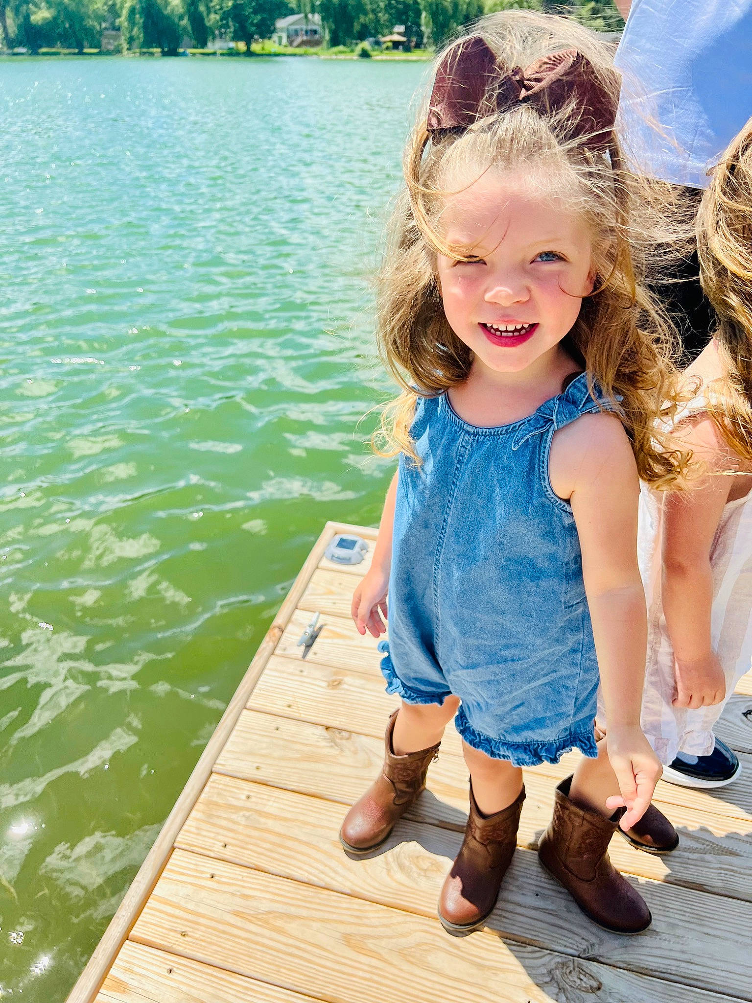 Milani is registered to the contest to win money with this photo: dress, fun, grass, hair, happy, lake, leisure, mammal, nature, people, people_in_nature, person, photograph, plant, recreation, smile, summer, toddler, tree, vertebrate