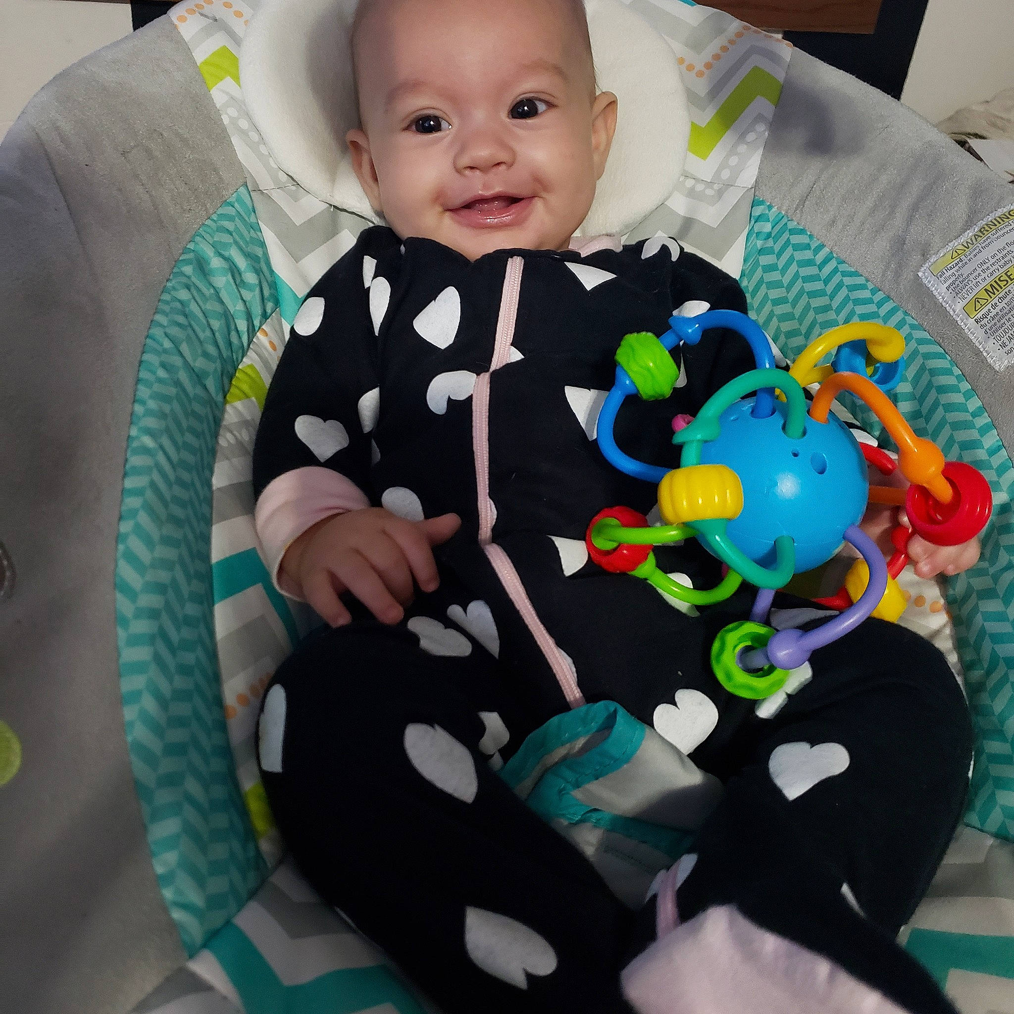 Amara joined the competition — help win amazing prizes! baby, baby_products, baby_safety, baby_toddler_clothing, baby_toys, child, comfort, face, facial_expression, green, happy, head, linens, pattern, person, room, sitting, sleeve, smile, t_shirt