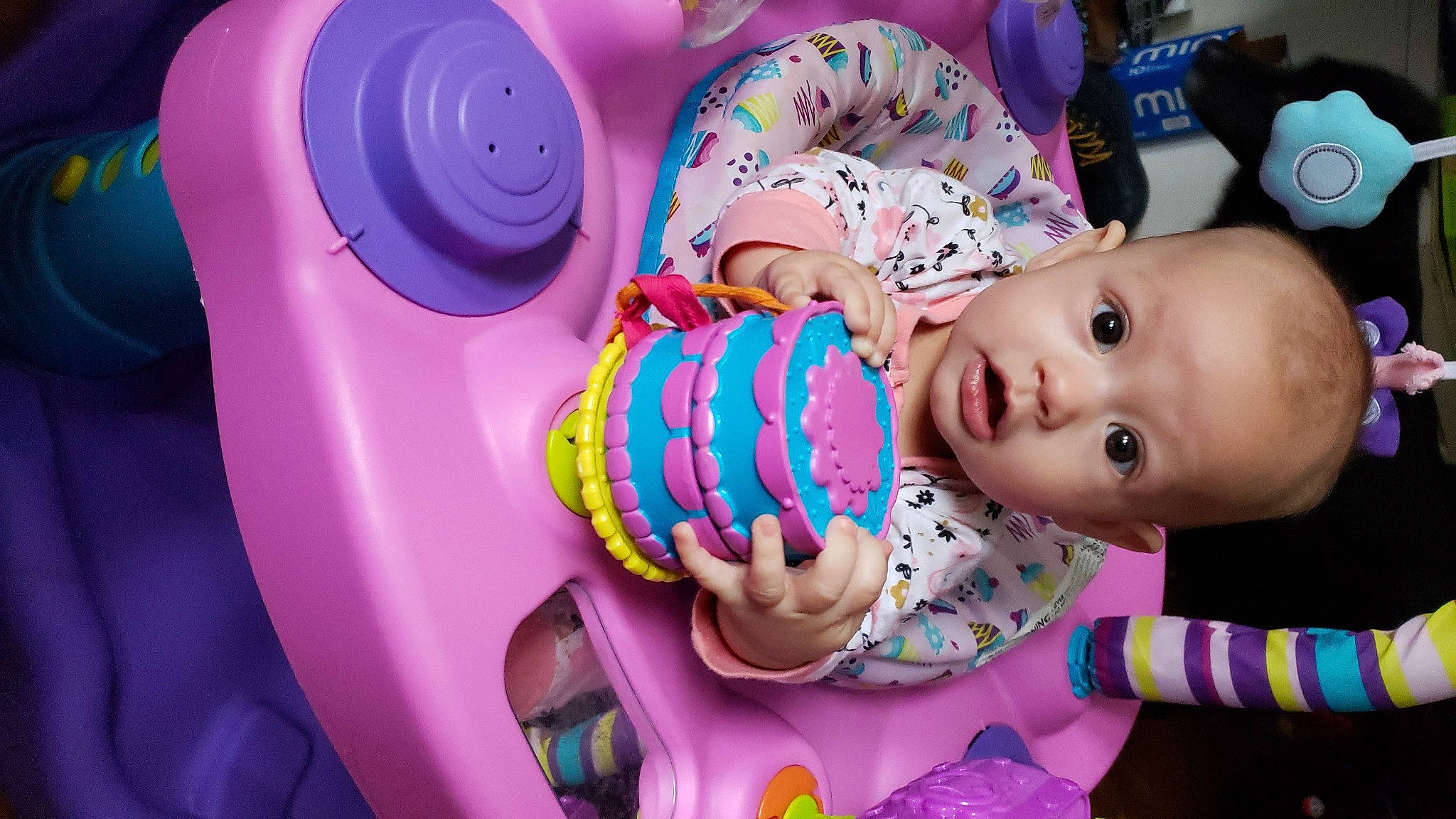 Amara is registered to the contest to win money with this photo: baby, baby_toddler_clothing, beauty, cheek, child, facial_expression, fun, hand, happy, lighting, party_supply, pattern, people, person, pink, product, purple, skin, textile, toddler