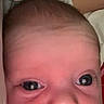 Kyleigh is registered to the contest to win money with this photo: baby, infant, face, closeup, video_call, woman, indoor, blanket, pink, expression, person, technology, screen, communication, portrait, head, young_child, curious, human, soft_lighting