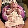 Kyleigh is registered to the contest to win money with this photo: baby, infant, pink_dress, headband, bow, pillow, princess_design, legs, indoor, carpet, sofa, cute, child, person, portrait, resting, clothing, comfortable, young, looking