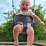 baby, child, clothing, daylight, face, fun, happy, infant, joy, legs, nature, outdoor, park, person, playground, sky, smile, summer, swing, trees