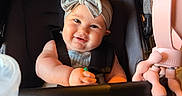 Kamryn joined the competition — help win amazing prizes! baby, bow, headband, stroller, child, smile, toy, pink, clothing, seatbelt, chicco, infant, happy, portrait, indoor, person, face, cute, baby_bottle, playtime