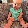 baby, child, chubby, couch, cozy, cute, face, furniture, happy, head, indoor, infant, mint_green, onesie, person, portrait, sitting, skin, smiling, toe