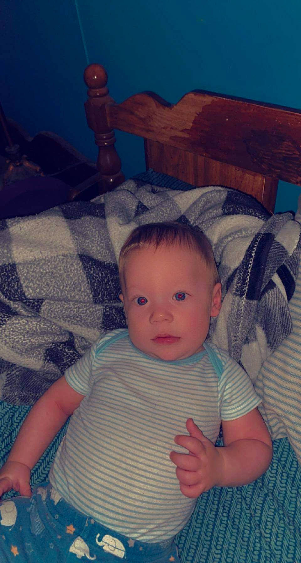 Jayden Harbert is registered to the contest to win money with this photo: arm, azure, baby, baby_toddler_clothing, cheek, child, chin, cool, electric_blue, eye, happy, head, iris, organ, pattern, person, sitting, skin, sleeve, tints_and_shades