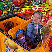 Rafaël a rejoint le concours — aidez-le/la à gagner de superbes lots ! amusement_ride, boy, cap, carnival, cartoon_art, child, colorful, denim_jacket, entertainment, fun, happy, indoor, lights, park, people, play, plush_toy, smiling, toy, vehicle