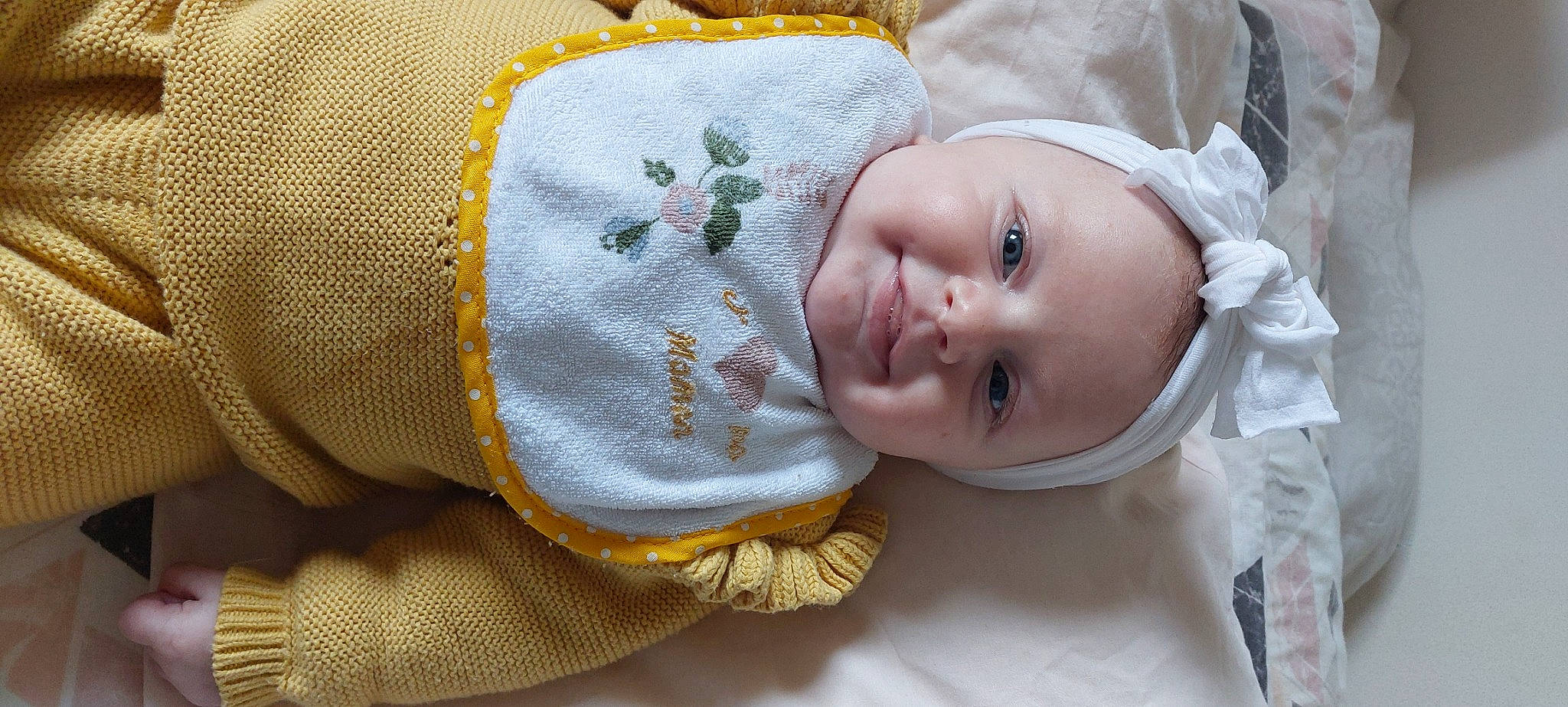 Ambre a rejoint le concours — aidez-le/la à gagner de superbes lots ! baby, baby_products, baby_toddler_clothing, comfort, eye, face, hand, happy, headgear, human_body, linens, outerwear, pattern, person, skin, sleeve, smile, textile, toddler, wool