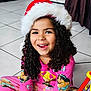 Kamilah is registered to the contest to win money with this photo: blackhair, bodypart, child, clothing, curlyhair, dimples, face, female, festival, girl, hair, happy, hat, head, mouth, pajamas, person, photography, portrait, smile