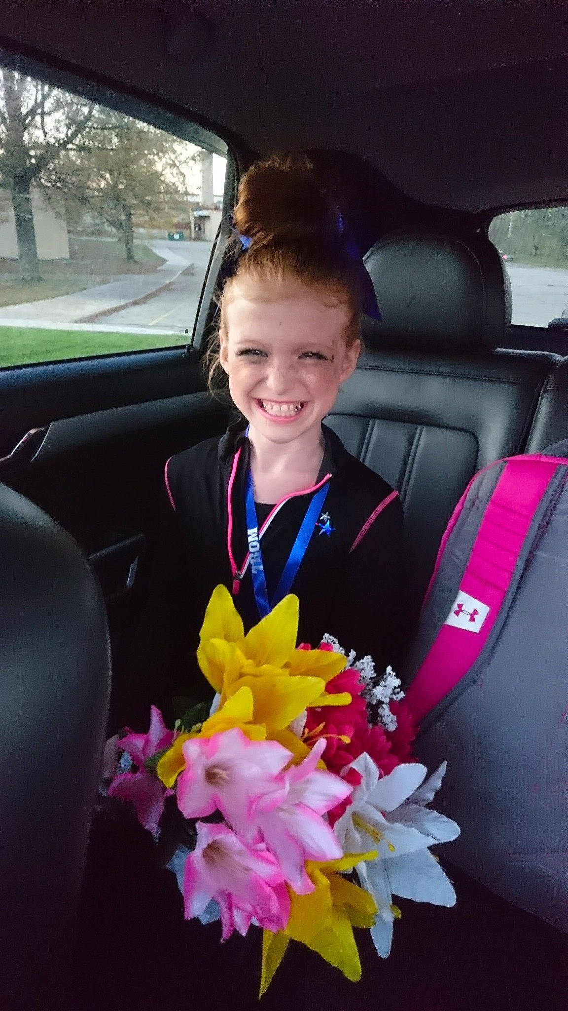 Gracey is registered to the contest to win money with this photo: car, car_seat, child, family_car, flower, fun, happy, joy, person, pink, plant, seat_belt, smile, vacation, vehicle, vehicle_door