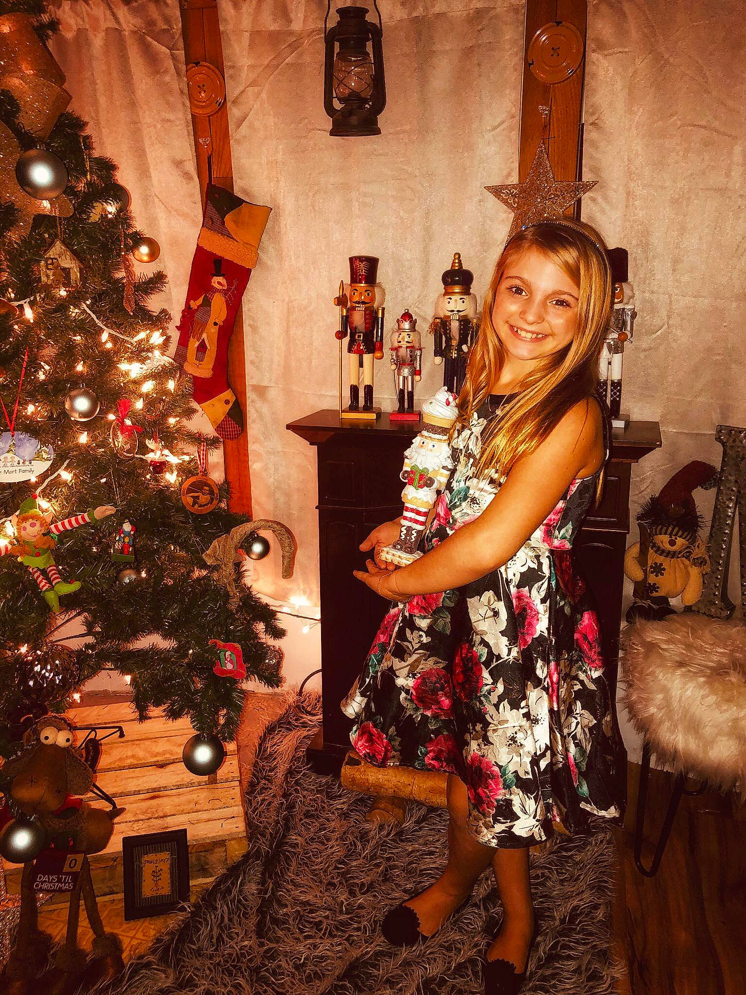 Gabriella joined the competition — help win amazing prizes! brown_hair, christmas, christmas_decoration, christmas_eve, christmas_ornament, christmas_tree, dress, fawn, fun, happy, holiday, interior_design, joy, long_hair, person, plant, smile, tree