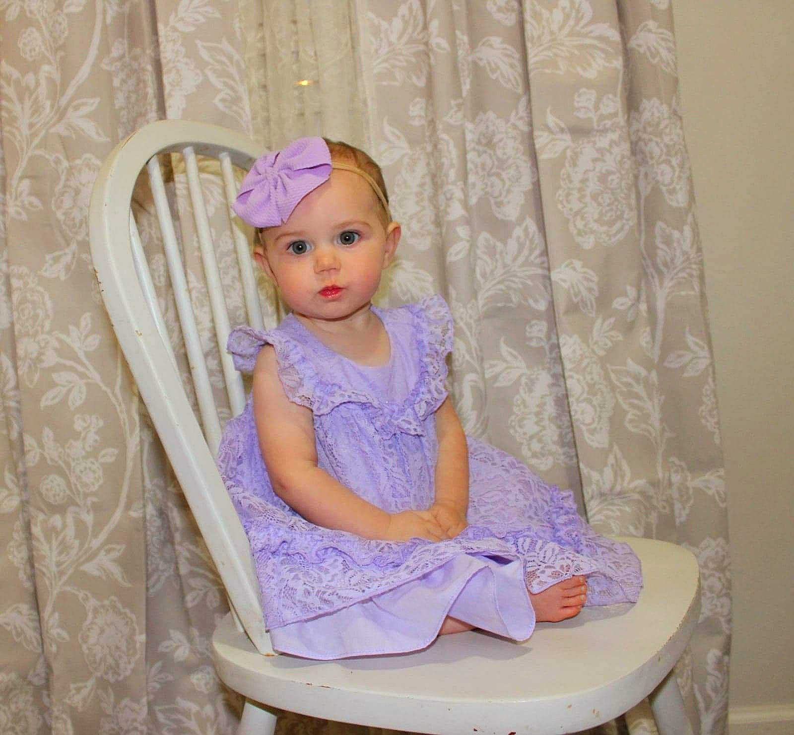 Athena joined the competition — help win amazing prizes! baby_toddler_clothing, blond, chair, child, curtain, electric_blue, embellishment, fashion_accessory, fashion_design, hair_accessory, headwear, magenta, pattern, person, pink, purple, room, sitting, sleeve, textile