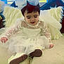 Ayat is registered to the contest to win money with this photo: toddler, child, white_dress, bow, sitting, couch, indoor, curly_hair, portrait, cute, soft_lighting, window, pillows, decor, smiling, young_child, fashion, happy, lace, shoes